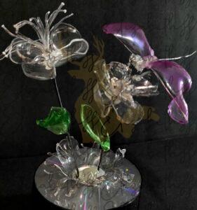 Recycled Plastic flowers and dragon fly on foam and CD